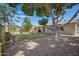 Backyard featuring desert landscaping, a mature tree, and manicured lawn at 2510 W Columbine Dr, Phoenix, AZ 85029