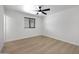 Bright bedroom featuring wood flooring and a contemporary ceiling fan at 2510 W Columbine Dr, Phoenix, AZ 85029