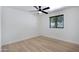 Empty room with light-colored flooring, a modern ceiling fan, and a window with dark blinds at 2510 W Columbine Dr, Phoenix, AZ 85029