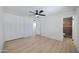 Bedroom boasts wood floors, ceiling fan, closet, and access to ensuite bathroom at 2510 W Columbine Dr, Phoenix, AZ 85029