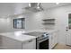 Beautiful kitchen with stainless steel oven, quartz countertops, large island, and white cabinets at 2510 W Columbine Dr, Phoenix, AZ 85029