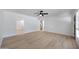 Spacious living room with wood-look flooring, modern ceiling fan, and ample natural light at 2510 W Columbine Dr, Phoenix, AZ 85029