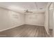 Spacious bedroom with modern ceiling fan and two windows for natural light and wood-look flooring at 2650 W Union Hills Dr # 16, Phoenix, AZ 85027
