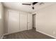 A bedroom with vinyl wood floors, a ceiling fan, and a large closet provides a cozy space at 2650 W Union Hills Dr # 16, Phoenix, AZ 85027