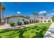 Community building with manicured lawn, palm trees, and a clearly visible American flag at 2650 W Union Hills Dr # 16, Phoenix, AZ 85027