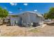 Back exterior view of home showing solar panels and covered parking in a sunny, desert landscape at 2650 W Union Hills Dr # 16, Phoenix, AZ 85027