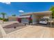 Inviting manufactured home with carport and well-maintained desert landscaping and flower planters at 2650 W Union Hills Dr # 16, Phoenix, AZ 85027