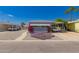 Charming manufactured home with desert landscaping, carport, and vibrant flower accents at 2650 W Union Hills Dr # 16, Phoenix, AZ 85027