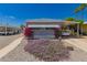 Charming home featuring a covered parking space with bright pink bougainvillea and purple flowers in the front yard at 2650 W Union Hills Dr # 16, Phoenix, AZ 85027