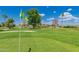Beautiful golf course with a green flag in the foreground on a sunny day at 2650 W Union Hills Dr # 16, Phoenix, AZ 85027