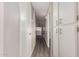 Bright hallway with wood-look flooring and built-in white cabinets, leading to the kitchen and other rooms at 2650 W Union Hills Dr # 16, Phoenix, AZ 85027