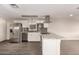 Modern kitchen with stainless steel appliances, granite countertops, an open view to the living area at 2650 W Union Hills Dr # 16, Phoenix, AZ 85027
