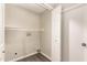 A well-lit laundry room features wood-look flooring, a utility sink hookup, and a storage shelf above at 2650 W Union Hills Dr # 16, Phoenix, AZ 85027