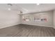 Spacious living room with wood-look flooring, natural light, and a ceiling fan at 2650 W Union Hills Dr # 16, Phoenix, AZ 85027