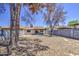 View of the house and partially covered patio, and large backyard enclosed by a block wall at 2845 E Irwin Ave, Mesa, AZ 85204