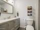 Bathroom featuring gray vanity with a white countertop and wood storage shelves at 2845 E Irwin Ave, Mesa, AZ 85204