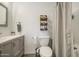 Bathroom featuring gray vanity with a white countertop and wood storage shelves at 2845 E Irwin Ave, Mesa, AZ 85204