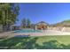 A serene community pool featuring a covered cabana and surrounding landscaping at 2845 E Irwin Ave, Mesa, AZ 85204