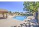 A refreshing community pool surrounded by lush greenery and a shaded seating area at 2845 E Irwin Ave, Mesa, AZ 85204