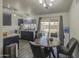 Charming kitchen with backyard view, featuring dark cabinets, light countertop, and a dining area at 2845 E Irwin Ave, Mesa, AZ 85204