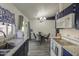 An open-concept kitchen leads to a dining area, featuring sleek dark cabinets and modern appliances at 2845 E Irwin Ave, Mesa, AZ 85204