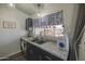 Granite counters and dark wood cabinets enhance this charming kitchen, brightened by a window view at 2845 E Irwin Ave, Mesa, AZ 85204