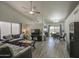 Bright and open living room featuring vaulted ceilings, neutral paint, wood-look floors, and large windows at 2845 E Irwin Ave, Mesa, AZ 85204