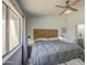 Tranquil bedroom featuring a wooden headboard, ceiling fan, and a large window for ample natural light at 2845 E Irwin Ave, Mesa, AZ 85204