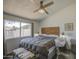 Bright bedroom with a wooden headboard, large window, and ceiling fan at 2845 E Irwin Ave, Mesa, AZ 85204
