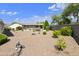 Spacious gravel backyard featuring desert landscaping and privacy wall, creating a serene outdoor retreat at 3301 S Goldfield Rd # 1010, Apache Junction, AZ 85119
