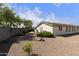 Gravel backyard with minimal desert landscaping, offering a low-maintenance outdoor space at 3301 S Goldfield Rd # 1010, Apache Junction, AZ 85119