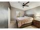 Cozy bedroom with soft carpet, modern ceiling fan, and natural light at 3301 S Goldfield Rd # 1010, Apache Junction, AZ 85119