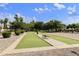Lush bocce ball court amidst mature landscaping provides a serene recreational space for leisure and enjoyment at 3301 S Goldfield Rd # 1010, Apache Junction, AZ 85119
