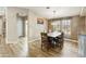 Charming dining area with natural light, rustic table, chandelier, and wood-look floors at 3301 S Goldfield Rd # 1010, Apache Junction, AZ 85119