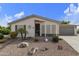 Charming single-story home with desert landscaping, gravel yard, and private two-car garage at 3301 S Goldfield Rd # 1010, Apache Junction, AZ 85119
