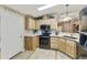 Well-equipped kitchen with black appliances, granite countertops, and wood cabinets at 3301 S Goldfield Rd # 1010, Apache Junction, AZ 85119