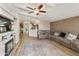 Cozy living room with plush seating, a fireplace, ceiling fan, and wood-look floors at 3301 S Goldfield Rd # 1010, Apache Junction, AZ 85119