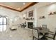 Inviting resident lounge with a fireplace, comfortable chairs, and elegant tile flooring at 3301 S Goldfield Rd # 1010, Apache Junction, AZ 85119