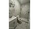 Well-lit bathroom featuring marble tile, vanity with white cabinets, and updated shower at 4049 N 81St Ave, Phoenix, AZ 85033