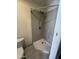 Bathroom featuring tiled shower, tile flooring, toilet, and chrome shower head at 4049 N 81St Ave, Phoenix, AZ 85033