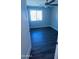 Bedroom with window, fan, and closet, with neutral paint and wood-look flooring at 4049 N 81St Ave, Phoenix, AZ 85033