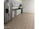 Bright kitchen featuring stainless steel appliances, white cabinets, and tile flooring at 4049 N 81St Ave, Phoenix, AZ 85033