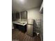Kitchenette area with stainless steel refrigerator, dark cabinets, and laminate flooring at 4049 N 81St Ave, Phoenix, AZ 85033