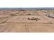 Extensive fenced property featuring a cozy home, scattering of small buildings, and an abundance of open land at 43384 W Padilla Rd, Maricopa, AZ 85138