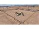 Expansive aerial view of a fenced property with a small home, mature trees and plenty of open space at 43384 W Padilla Rd, Maricopa, AZ 85138