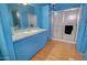 This simple bathroom features a shower, a vanity with a sink, and clean lines for a functional space at 43384 W Padilla Rd, Maricopa, AZ 85138