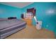 A simple bedroom includes essential furnishings and a neutral carpet, providing a practical space for rest at 43384 W Padilla Rd, Maricopa, AZ 85138