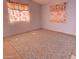 A spacious empty room is shown with patterned flooring and natural lighting, ready for customization and use at 43384 W Padilla Rd, Maricopa, AZ 85138