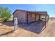 Shows the side of the home with a covered area, utility access, and lots of potential at 43384 W Padilla Rd, Maricopa, AZ 85138