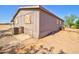 Side exterior of single-story home highlighting the siding, foundation, and AC unit at 43384 W Padilla Rd, Maricopa, AZ 85138